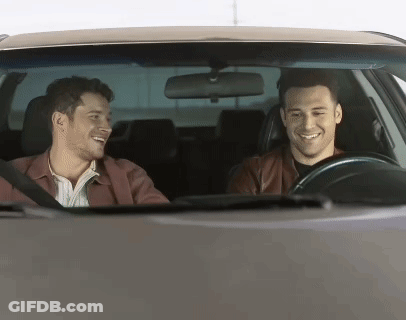Two Men Smiling And Laughing In Car GIF