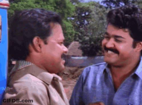 Two Men Smiling Next To Each Other GIF