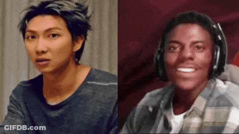 Two Men Smiling, One With Headphones GIF