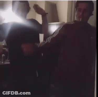 Two Men Smoking Cigarettes In Dark Room GIF