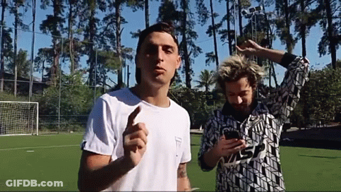 Two Men Soccer Field One Looking At Phone GIF