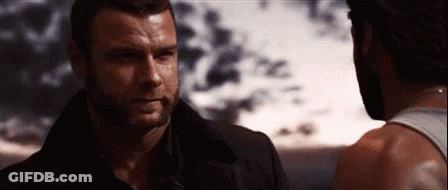 Two Men Standing And Looking At Each Other GIF