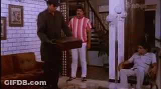Two Men Standing And Man Sitting In Living Room GIF
