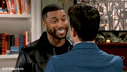 Two Men Standing And Smiling At Each Other GIF