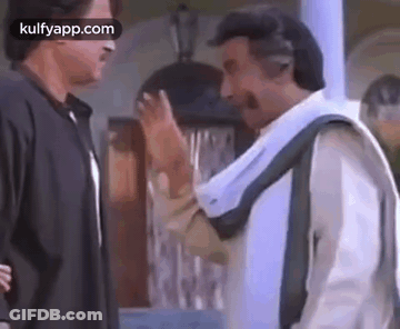 Two Men Standing And Talking In Room GIF