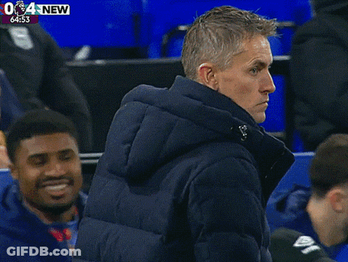 Two Men Standing At 6:55 GIF