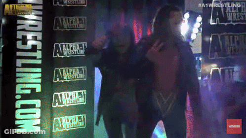 Two Men Standing Before Alpha-1 Sign GIF