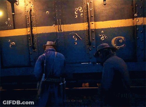 Two Men Standing Before Bullet-Hole Train Saying Target The Fuck GIF