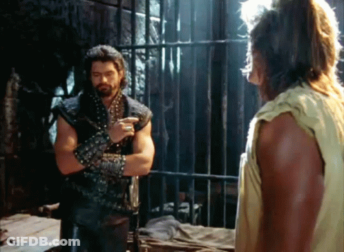 Two Men Standing Behind Bars In Dark Room GIF