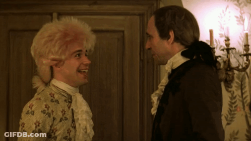 Two Men Standing Beside Candles On Wall GIF
