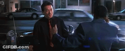Two Men Standing Beside Car On Street GIF