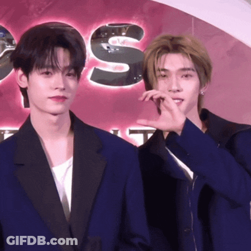 Two Men Standing Beside Sign Saying S GIF