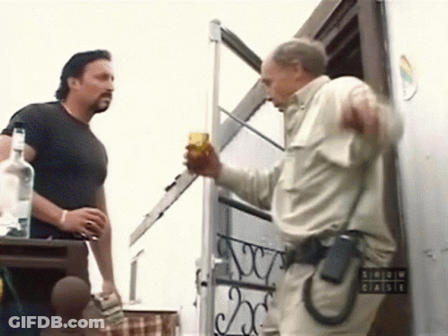 Two Men Standing By Arrow Chaise Sign GIF