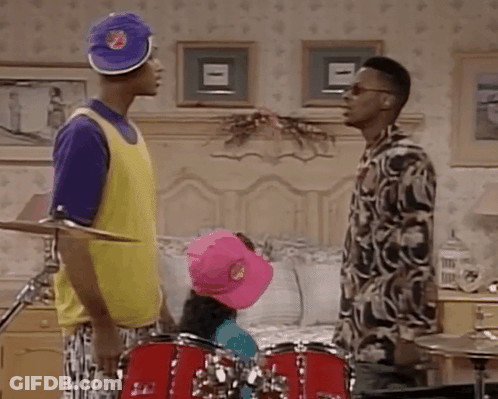 Two Men Standing By Drum Set In Bedroom GIF