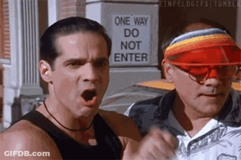 Two Men Standing By One Way Do Not Enter Sign GIF