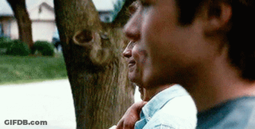 Two Men Standing By Tree GIF