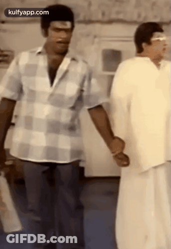 Two Men Standing Holding Hands Talking GIF