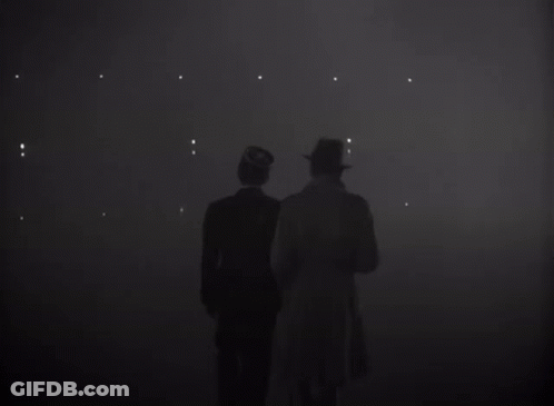 Two Men Standing In A Dark Room With The Word Louis On The Bottom GIF