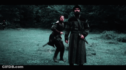 Two Men Standing In A Field With The Words Grandson Of Otoman On The Bottom Right GIF