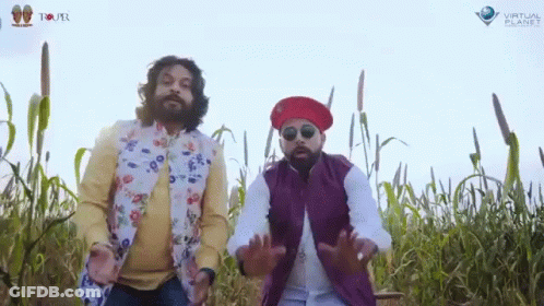 Two Men Standing In A Field With Virtual Planet Written On The Bottom Right GIF