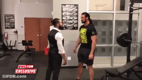 Two Men Standing In A Gym With Wwe.com Exclusive Written On The Screen GIF