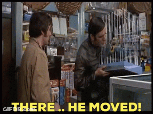 Two Men Standing In A Store With The Words " There He Moved " On The Bottom GIF