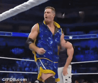Two Men Standing In A Wrestling Ring With A Banner That Says Down On It GIF