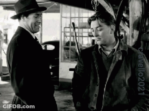 Two Men Standing In Black And White Photo By Travelo24 GIF