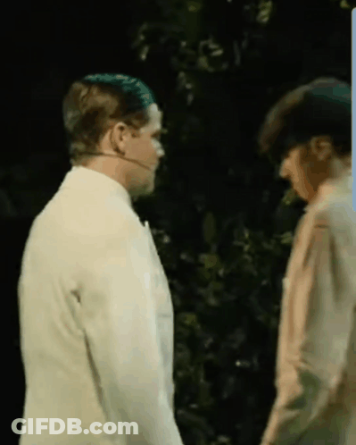 Two Men Standing In Dark Room With Trees GIF