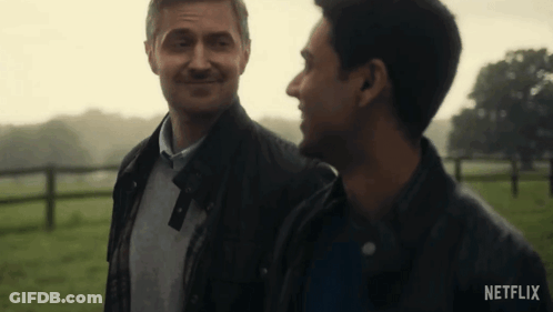 Two Men Standing In Field With Netflix Logo GIF