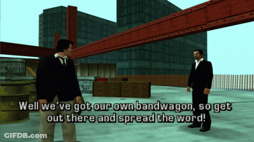 Two Men Standing In Front Of A Building With The Words Well We 'Ve Got Our Own Bandwagon So Get Out There And Spread The GIF