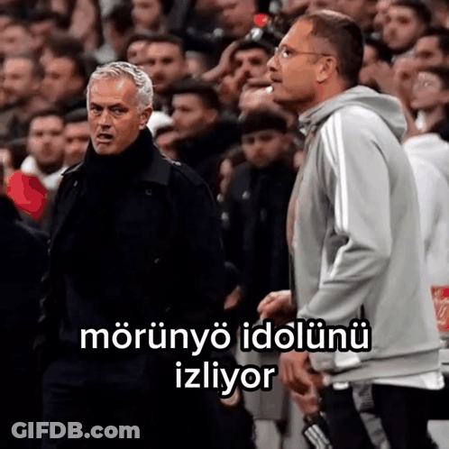 Two Men Standing In Front Of A Crowd With A Caption That Says Morunyo Idolunu Izliyor . GIF