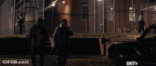 Two Men Standing In Front Of A Fence With The Word Bet On The Bottom GIF