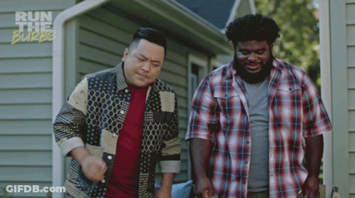 Two Men Standing In Front Of A House With The Words Run The Burbs On The Bottom Right GIF
