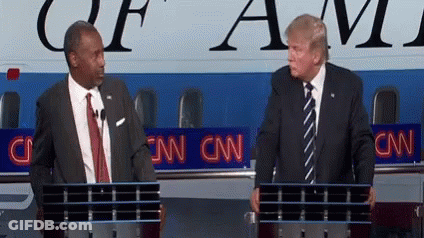 Two Men Standing In Front Of A Podium With Cnn Written On It GIF