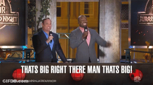 Two Men Standing In Front Of A Sign That Says " Thats Big Right There Man Thats Big " GIF