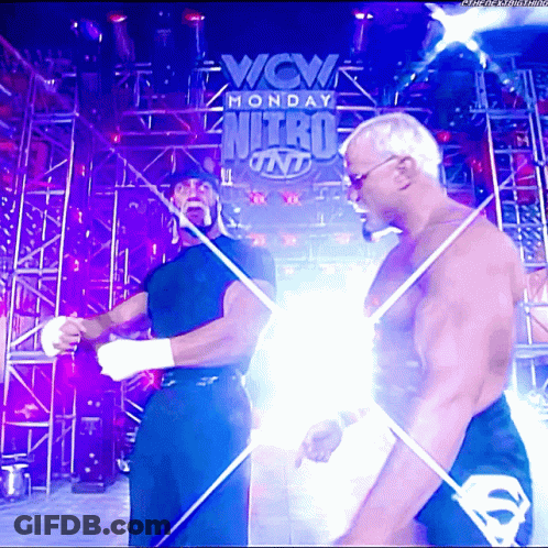 Two Men Standing In Front Of A Sign That Says Wcw Monday Nitro On It GIF