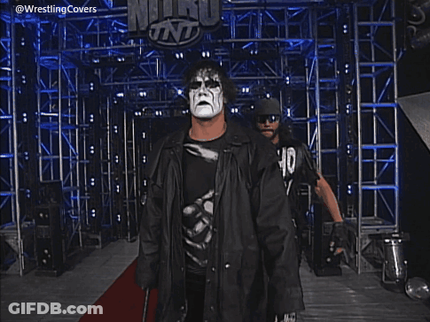 Two Men Standing In Front Of A Sign That Says Wcw Monday Nitro GIF