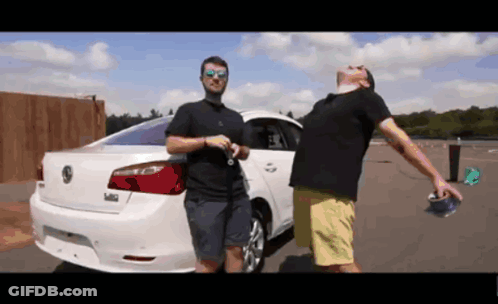 Two Men Standing In Front Of A White Volkswagen GIF
