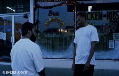 Two Men Standing In Front Of Bro's Ribs GIF