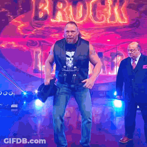 Two Men Standing In Front Of Brock Sign GIF