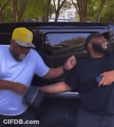 Two Men Standing In Front Of Car GIF