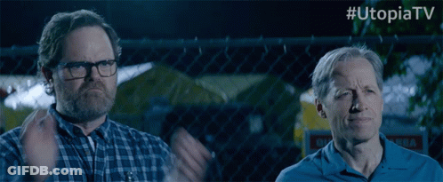 Two Men Standing In Front Of Chain Link Fence #UtopiaTV GIF