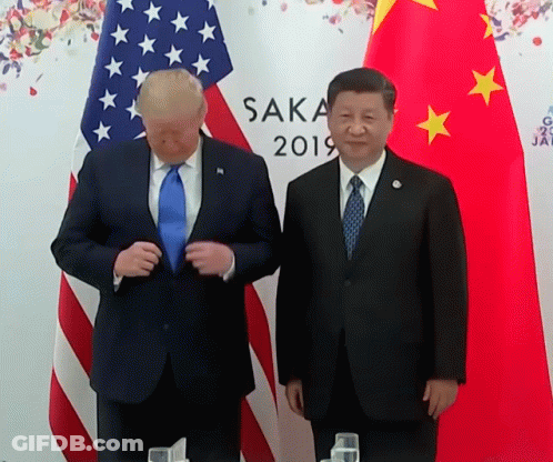 Two Men Standing In Front Of Flags With Saka 2019 On The Wall GIF