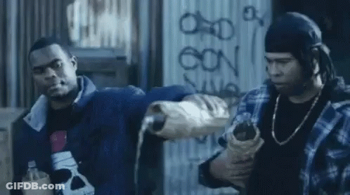 Two Men Standing In Front Of Graffiti Wall GIF