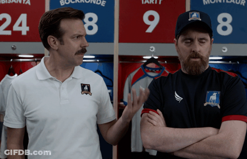 Two Men Standing In Front Of Lockers 24 And 9 GIF