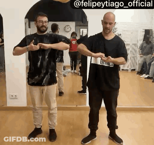 Two Men Standing In Front Of Mirror GIF