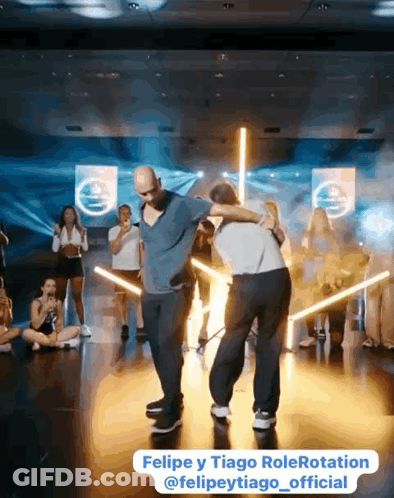 Two Men Standing In Front Of Mirror GIF