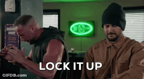 Two Men Standing In Front Of Neon Lock It Up Sign GIF