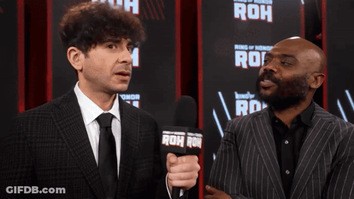 Two Men Standing In Front Of Ring Of Honor Sign GIF
